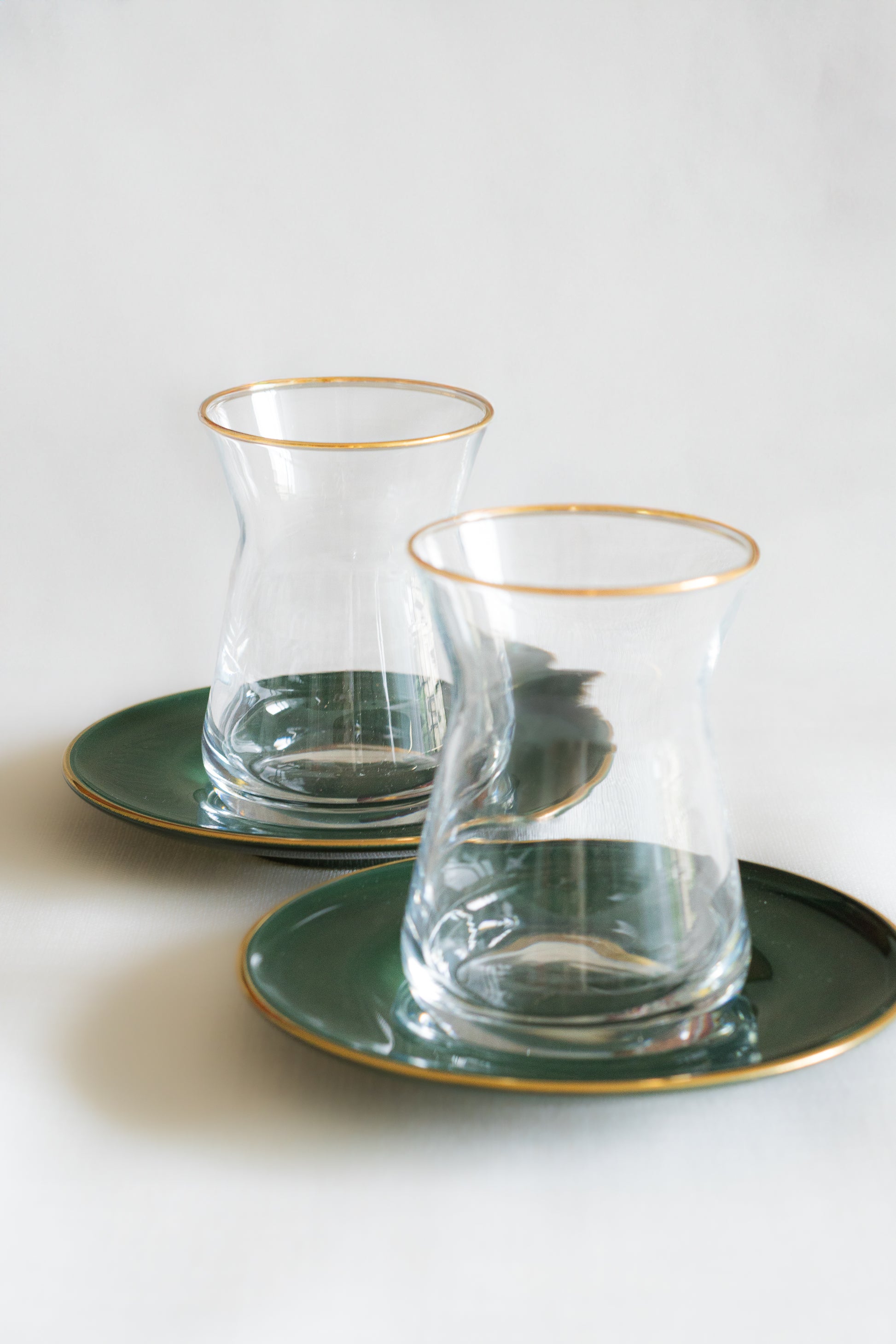 verres à the et sous tasses vertes bordees dor refletant leclat et lauthenticitée de la decoration traditionnelle marocaine